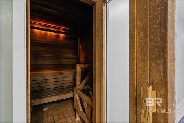 view of sauna featuring wooden walls