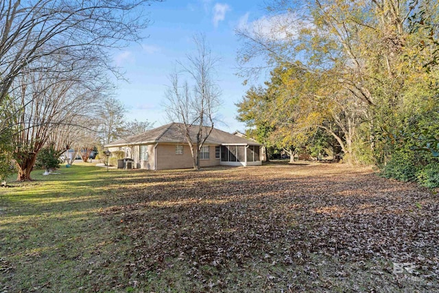 exterior space featuring a lawn and a sunroom