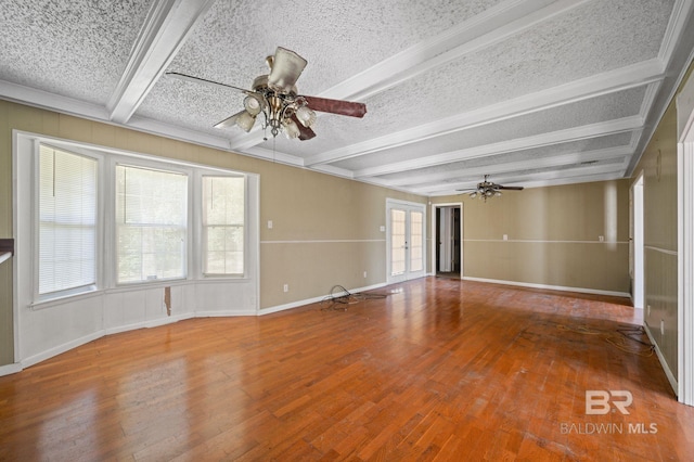 interior space featuring beamed ceiling, a textured ceiling, wood-type flooring, and ceiling fan