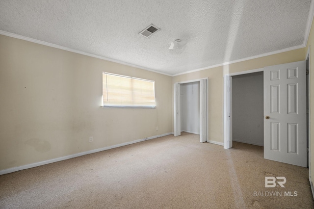 unfurnished bedroom with light carpet, crown molding, and a textured ceiling