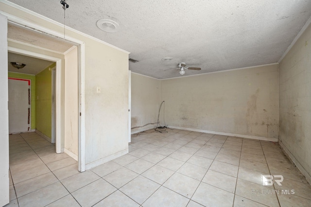 empty room with a textured ceiling, light tile patterned floors, crown molding, and ceiling fan