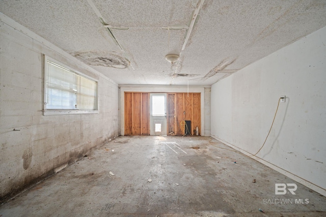 unfurnished room featuring concrete floors