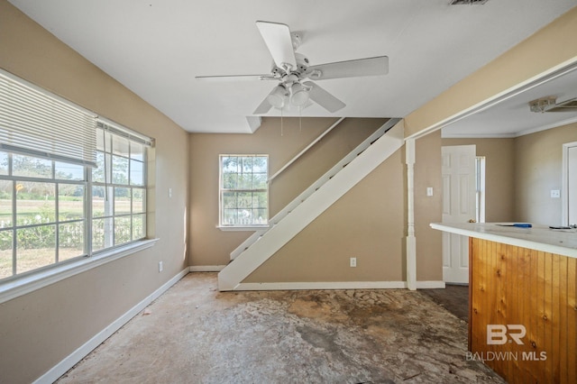 interior space with ceiling fan