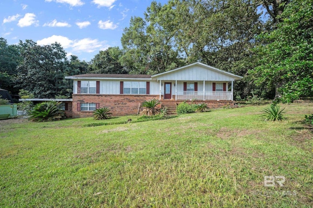 ranch-style home with covered porch and a front yard