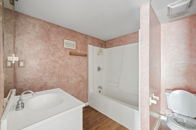 full bathroom featuring tub / shower combination, vanity, toilet, and hardwood / wood-style floors