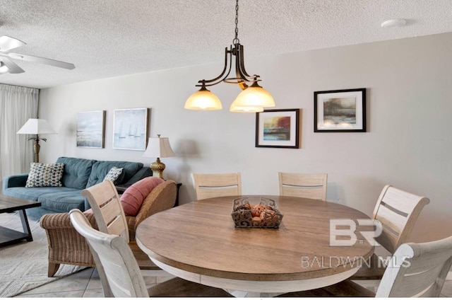 dining space featuring a textured ceiling and ceiling fan