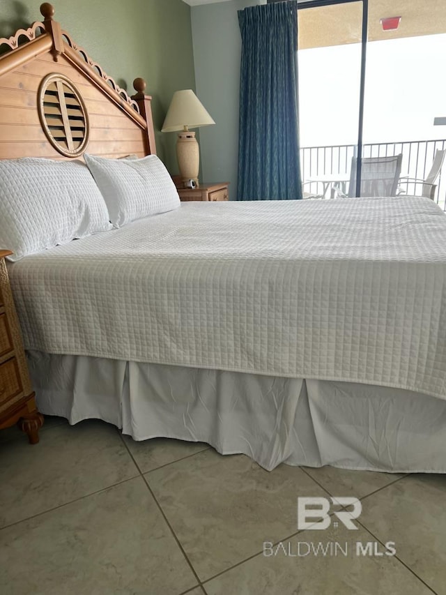 tiled bedroom with access to outside
