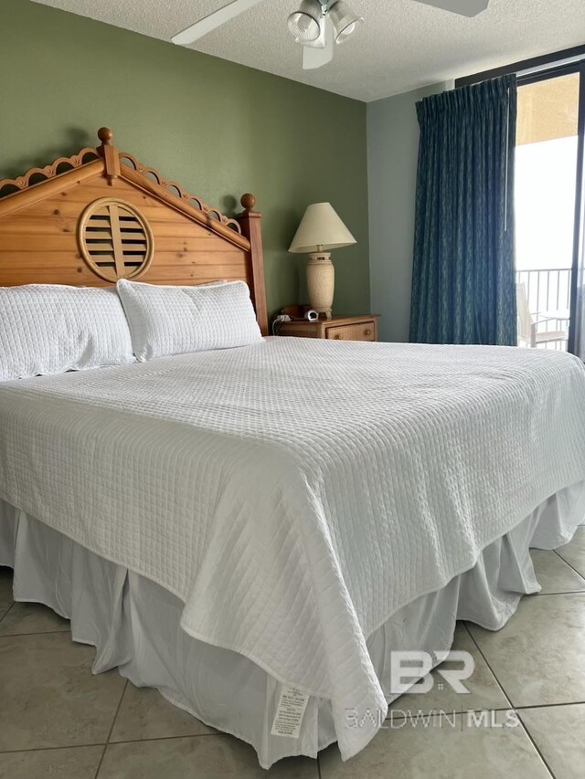 bedroom with tile patterned flooring and a textured ceiling