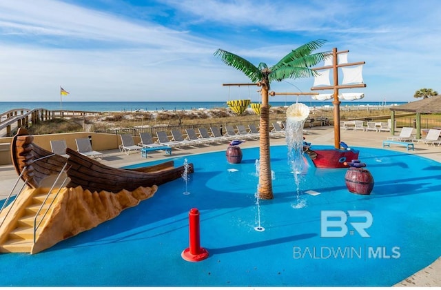 pool featuring a patio, fence, and a water view