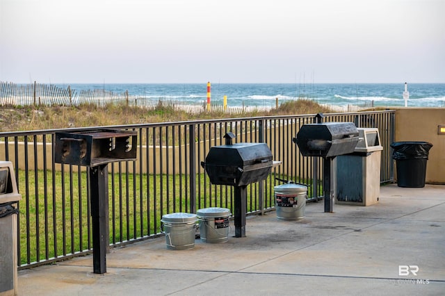 balcony featuring a water view, a view of the beach, and area for grilling