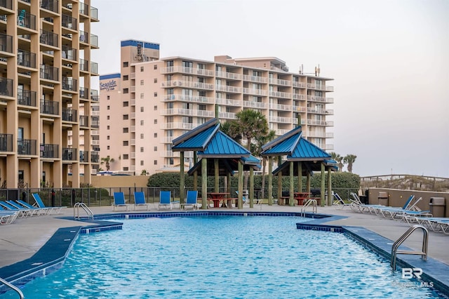 community pool featuring a patio area and fence