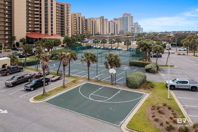 view of basketball court featuring community basketball court, a city view, and a tennis court