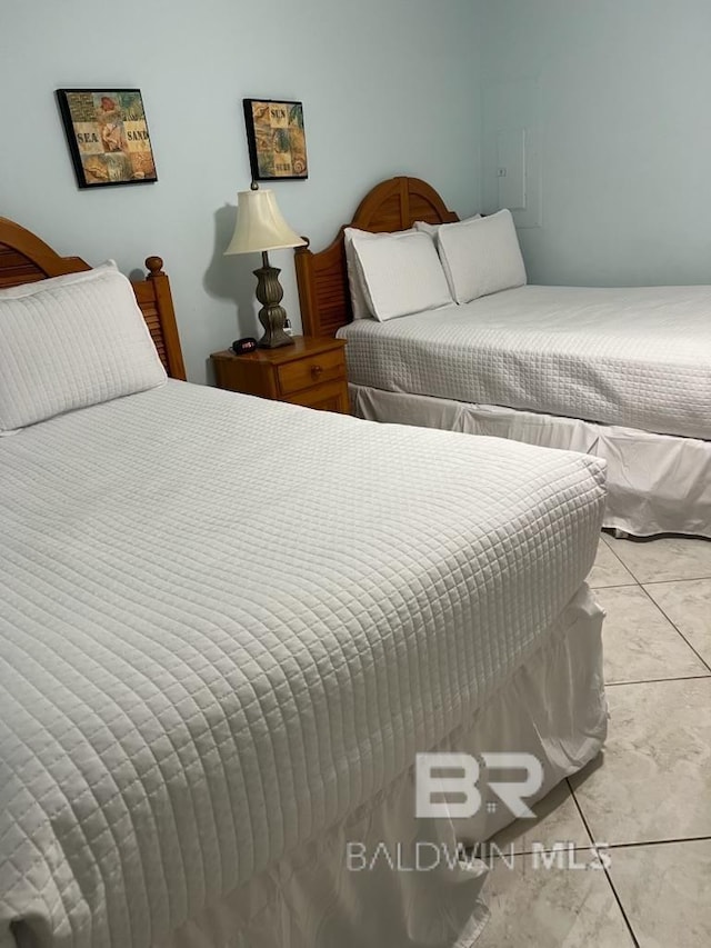 bedroom with light tile patterned floors