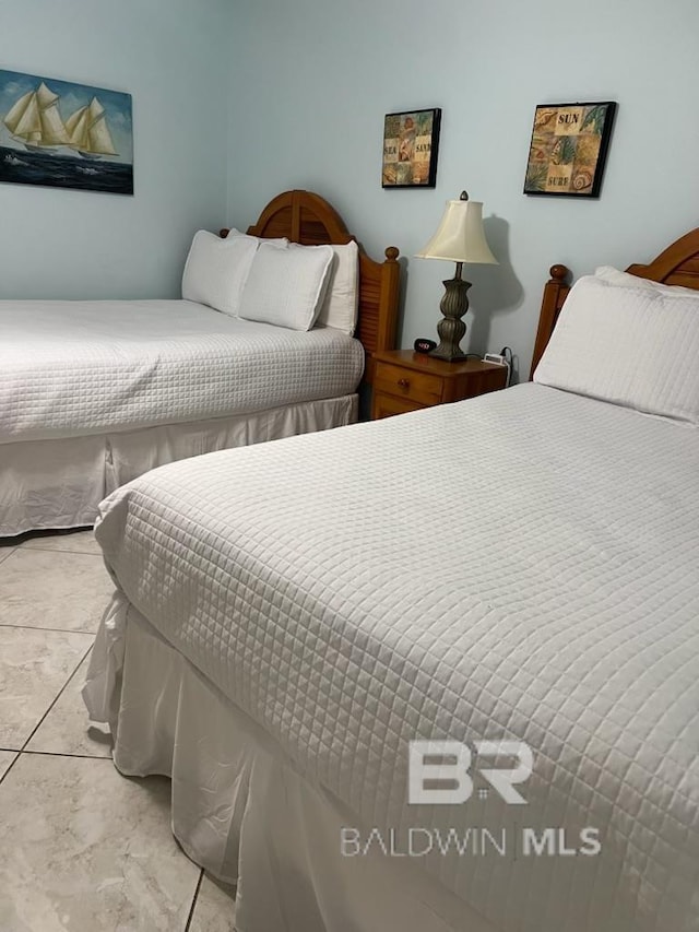 bedroom featuring marble finish floor