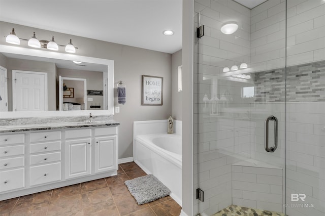 25697 Overlook Dr, Loxley, AL 36551 - bathroom with double vanity, a garden tub, a stall shower, and tile patterned floors