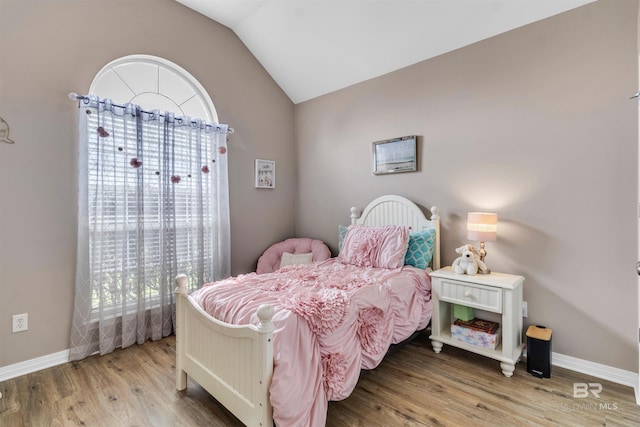 25697 Overlook Dr, Loxley, AL 36551 - bedroom with lofted ceiling, wood finished floors, and baseboards