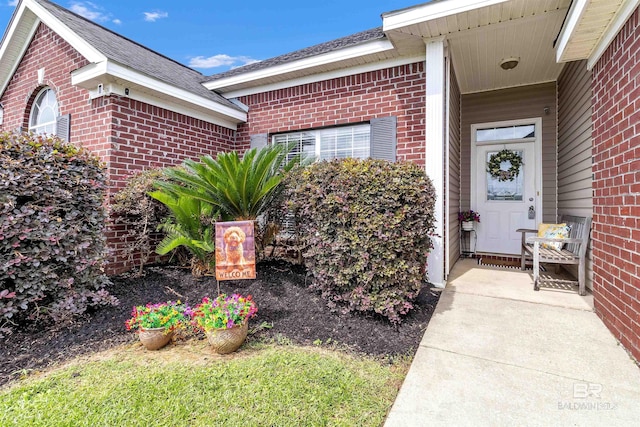 25697 Overlook Dr, Loxley, AL 36551 - view of exterior entry featuring brick siding and roof with shingles