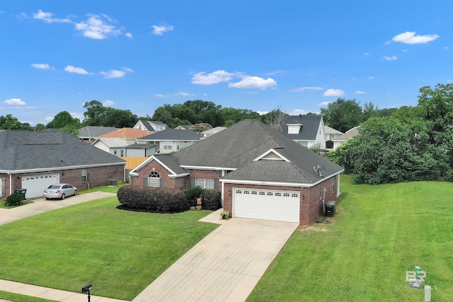 25697 Overlook Dr, Loxley, AL 36551 - traditional-style home featuring brick siding, a front lawn, driveway, and an attached garage