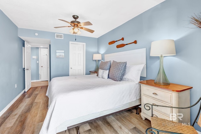 bedroom featuring baseboards, visible vents, ceiling fan, wood finished floors, and a closet