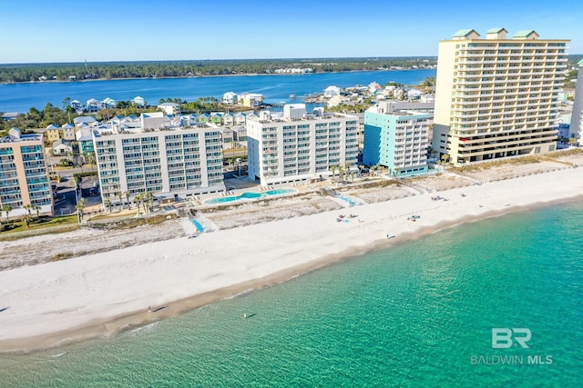 birds eye view of property with a water view, a view of city, and a beach view