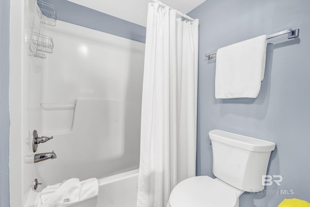 bathroom with toilet and shower / bath combo with shower curtain