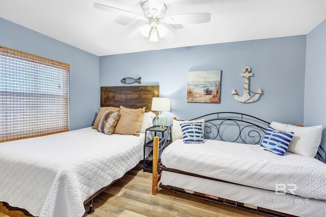 bedroom featuring a ceiling fan and wood finished floors