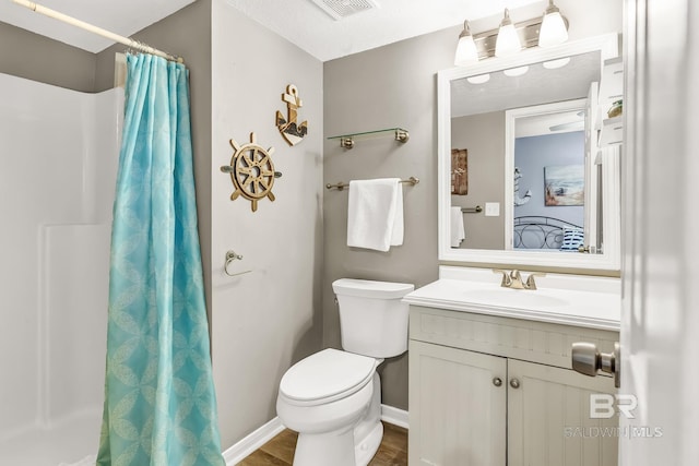 bathroom featuring baseboards, visible vents, toilet, a shower with curtain, and vanity