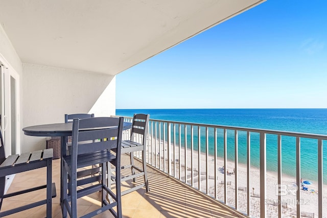 balcony with a beach view and a water view