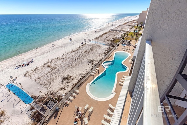 bird's eye view with a water view and a beach view