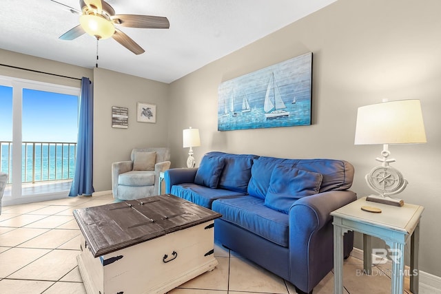 living area featuring a ceiling fan and light tile patterned flooring