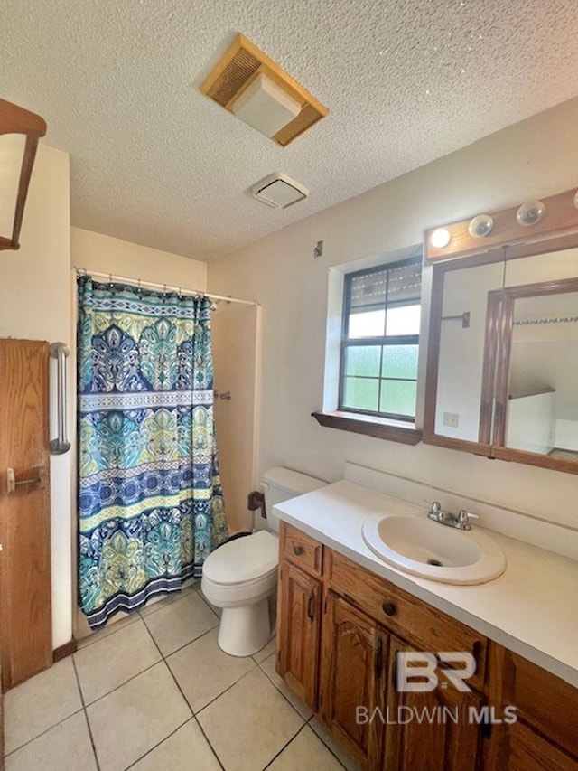 full bathroom featuring tile patterned flooring, vanity, toilet, a textured ceiling, and a shower with curtain