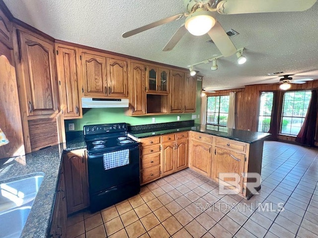 kitchen featuring electric range, ceiling fan, a textured ceiling, light tile patterned floors, and under cabinet range hood