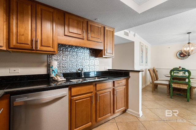 kitchen featuring a notable chandelier, a sink, hanging light fixtures, stainless steel dishwasher, and brown cabinetry