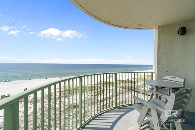 balcony featuring a water view and a view of the beach