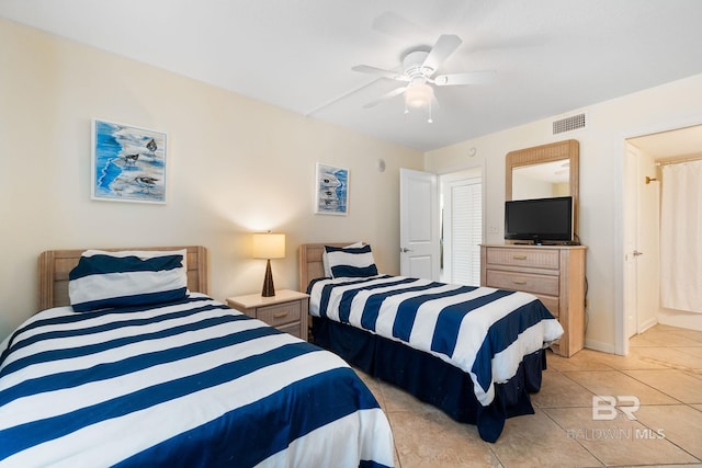 bedroom with visible vents, a ceiling fan, and light tile patterned flooring