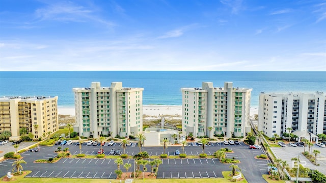 drone / aerial view featuring a water view and a view of the beach