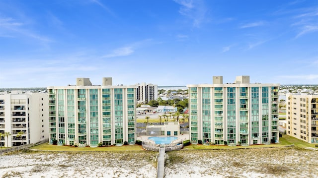 view of building exterior with a water view and a city view