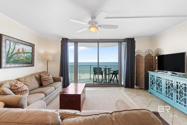 living area featuring a textured ceiling, a ceiling fan, crown molding, and light tile patterned flooring