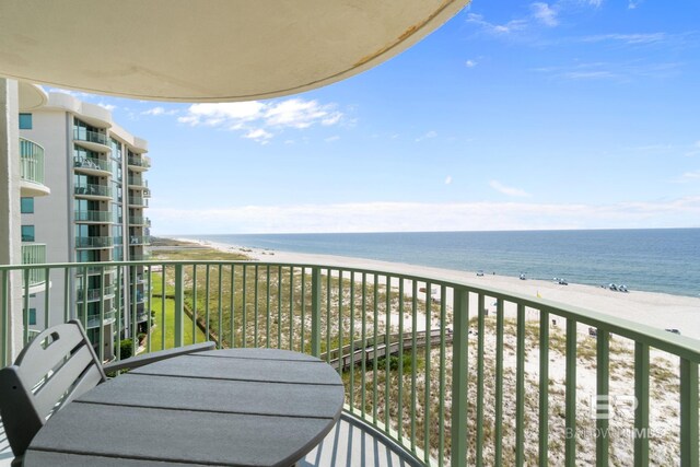 balcony with a water view and a beach view