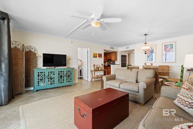 living area featuring ornamental molding, ceiling fan with notable chandelier, and light tile patterned floors