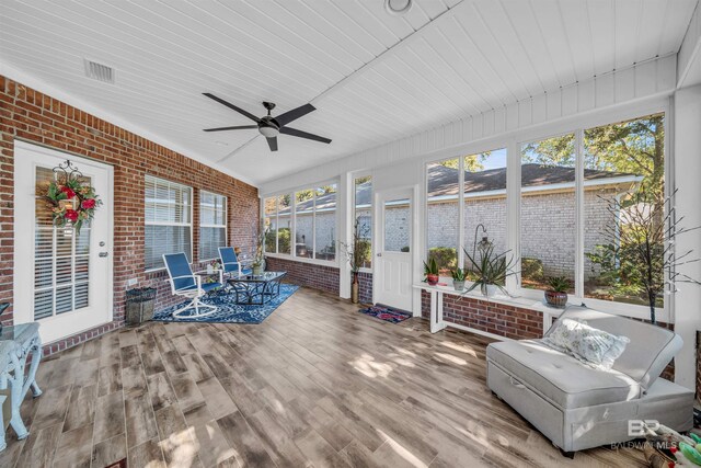 sunroom / solarium featuring ceiling fan and wood ceiling