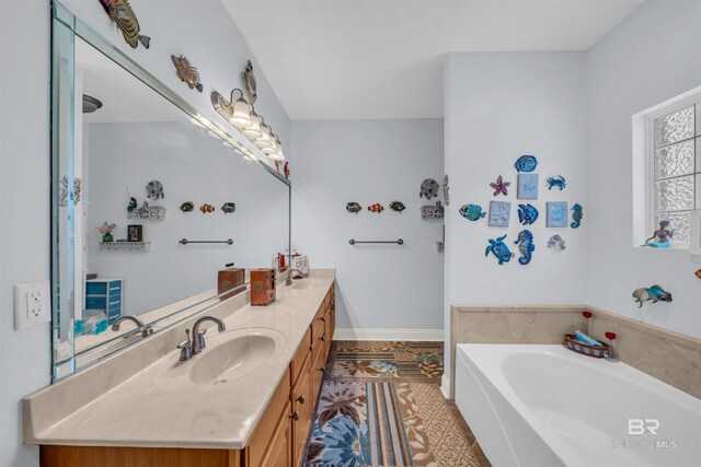 bathroom with a bath, vanity, and tile patterned floors