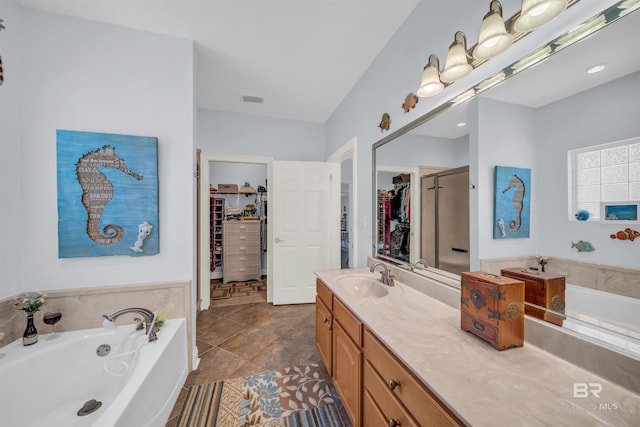 bathroom with tile patterned floors, vanity, and separate shower and tub