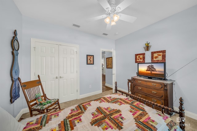 bedroom with ceiling fan, a closet, and light carpet