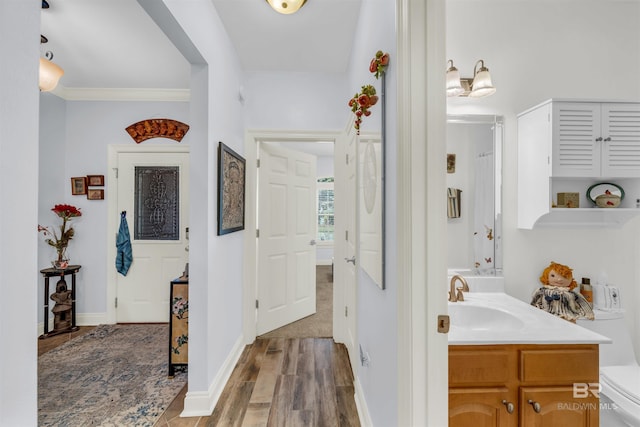 bathroom with vanity, hardwood / wood-style flooring, toilet, and crown molding