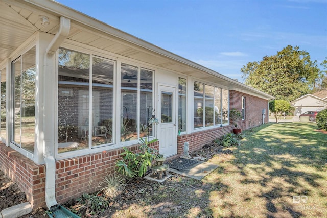 exterior space with a yard and a sunroom