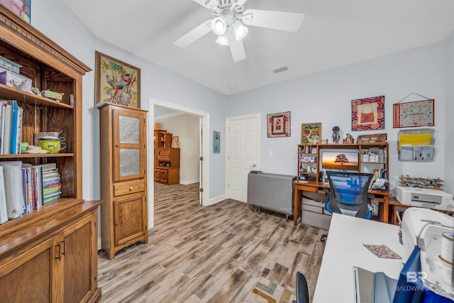 office space with light hardwood / wood-style flooring and ceiling fan