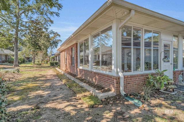 view of home's exterior with a sunroom