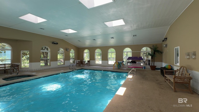 view of swimming pool featuring a skylight