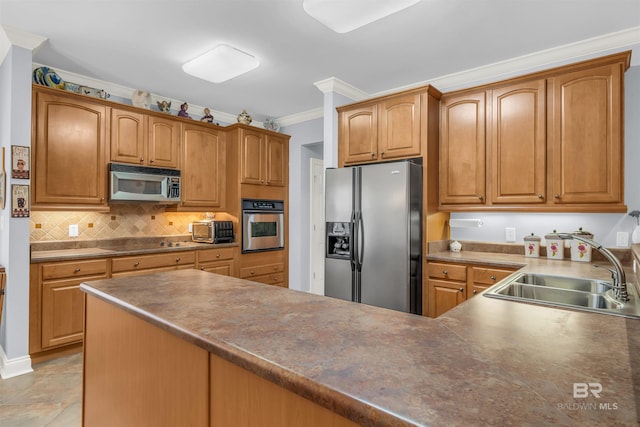 kitchen featuring backsplash, crown molding, sink, and stainless steel appliances